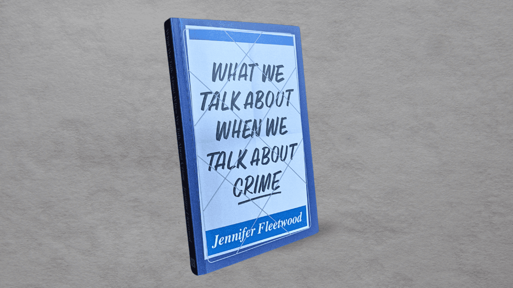 A copy of What We Talk About When We Talk About Crime by Jennifer Fleetwood on a grey background